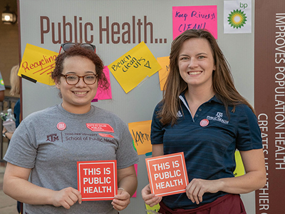 two students promoting national public health week